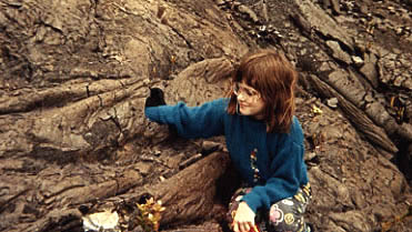 Photo of Megaera with her hand in a little lava tube.